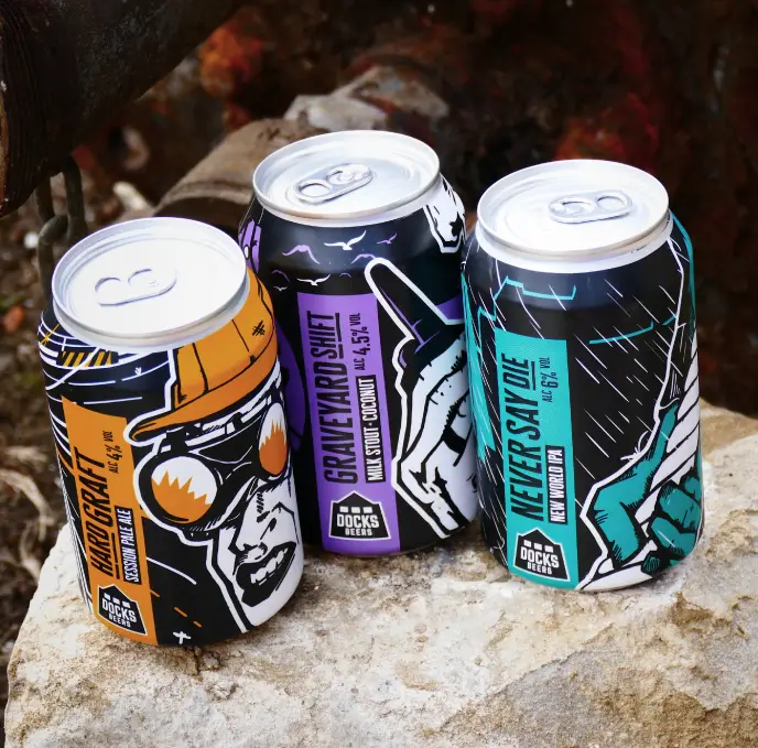 Three Docks Beers cans on a rock