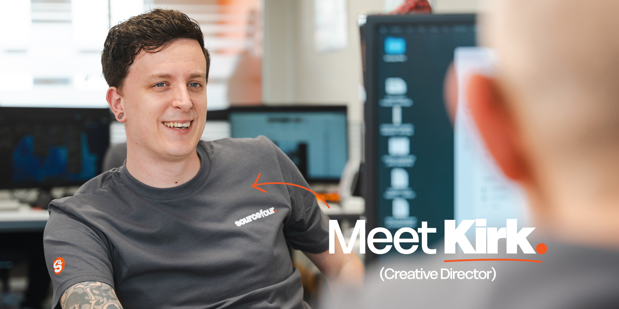 Meet the S4 Team - Sourcefour Creative Director Kirk laughing in the studio on an orange backdrop.
