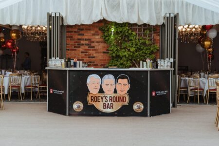A tent with a sign celebrating Jon Roe Toyota's 50 years in business and winning the Sourcefour Ichiban Award.