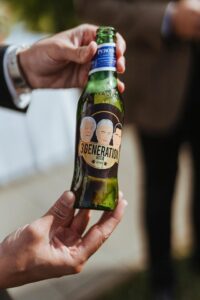 A man helps Toyota mark 50 years in business with a branded beer bottle.
