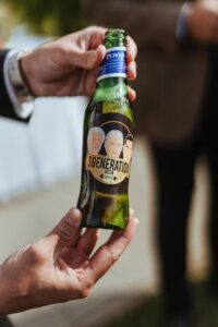 A man helps Toyota mark 50 years in business with a branded beer bottle.