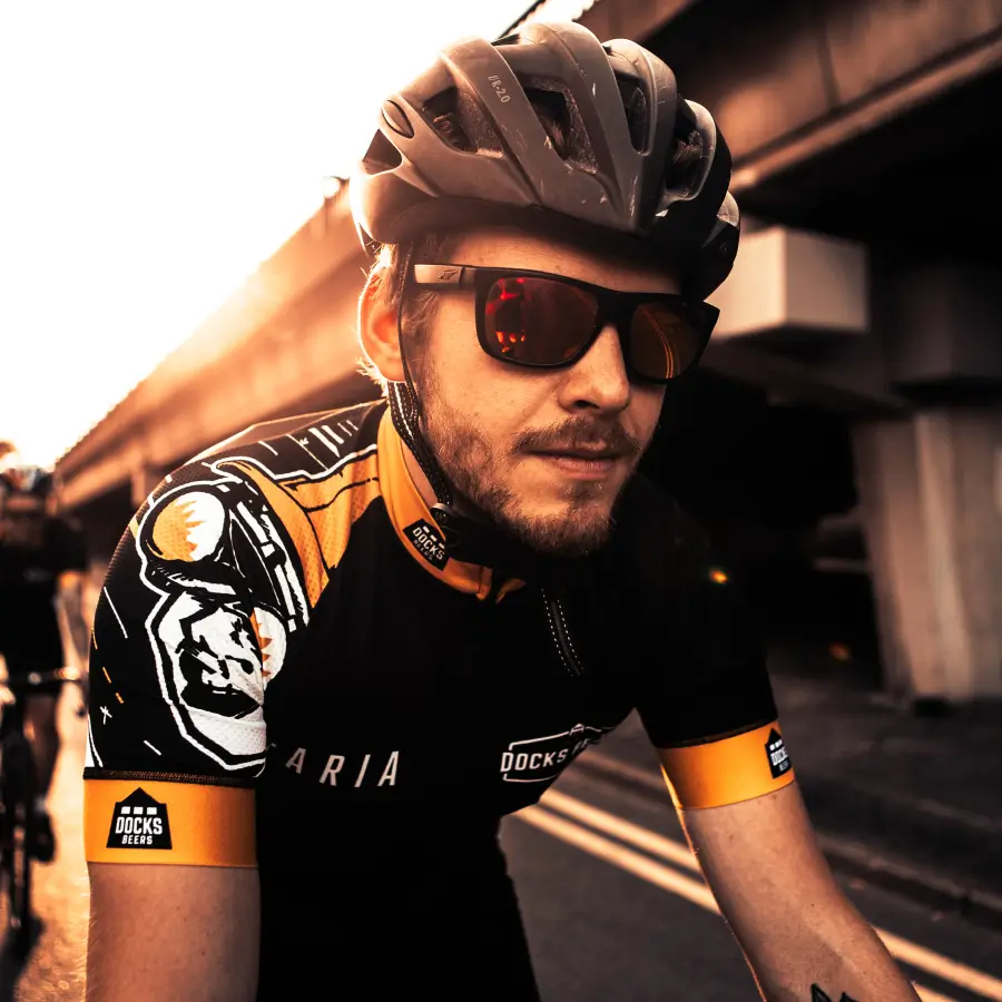 Man riding his bike in a docks beers branded top